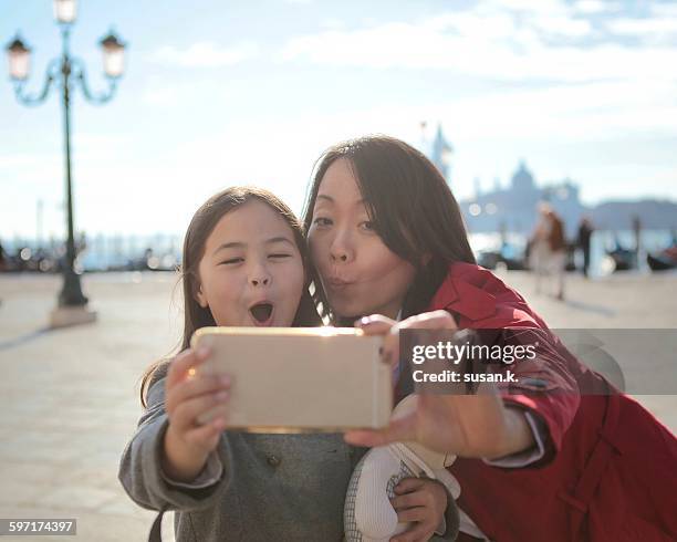 mother and daughter take funny faces selfie - funny face stock pictures, royalty-free photos & images