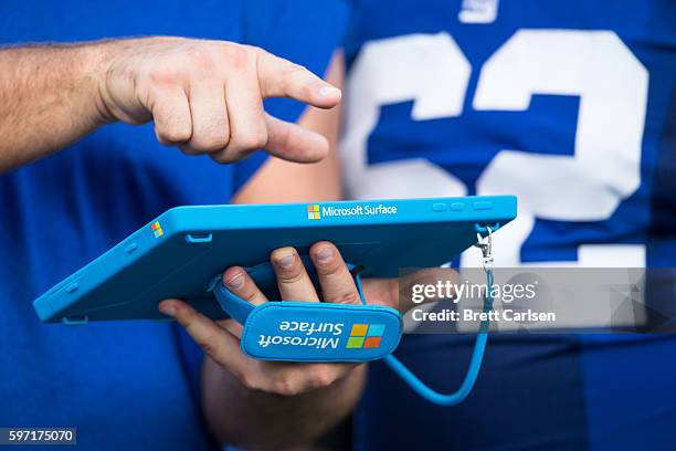 Members of the New York Giants go over game plans on a Microsoft Surface tablet during the game against the Buffalo Bills on August 20, 2016 at New...