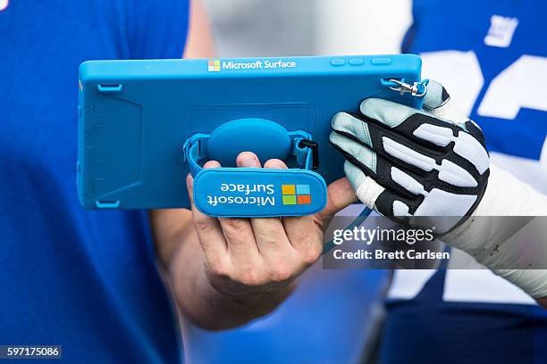 Members of the New York Giants go over game plans on a Microsoft Surface tablet during the game against the Buffalo Bills on August 20, 2016 at New...