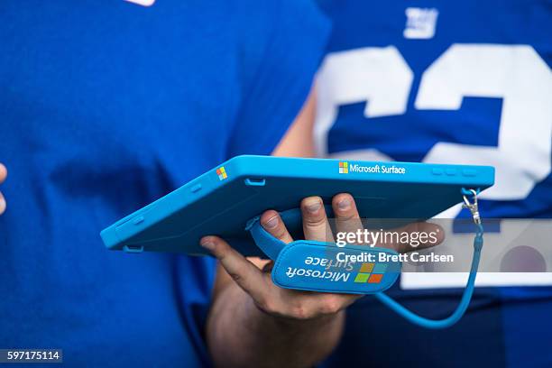 Members of the New York Giants go over game plans on a Microsoft Surface tablet during the game against the Buffalo Bills on August 20, 2016 at New...