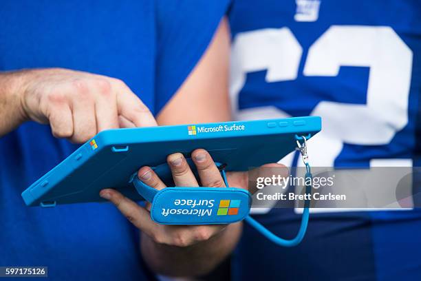 Members of the New York Giants go over game plans on a Microsoft Surface tablet during the game against the Buffalo Bills on August 20, 2016 at New...
