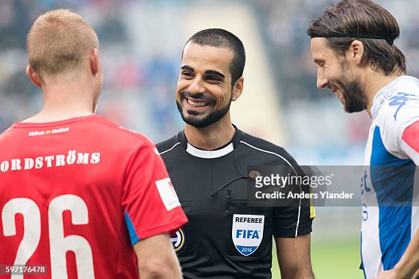 The referee Mohammed Al-Hakim talks to Peter Larsson of Helsingborgs IF and Mattias Bjarsmyr of IFK Goteborg prior the Allsvenskan match between IFK...