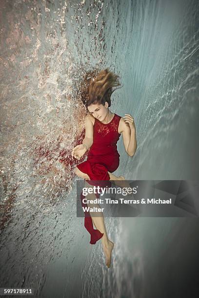 a woman in red dress underwater - north sea under water stock pictures, royalty-free photos & images