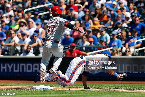 James Loney of the New York Mets holds onto a wide throw for a first-inning force out against Odubel Herrera of the Philadelphia Phillies at Citi...