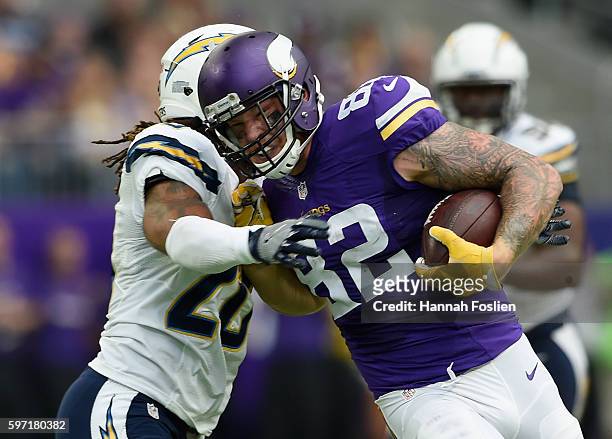 Dwight Lowery of the San Diego Chargers tackles Kyle Rudolph of the Minnesota Vikings during the second quarter of the game on August 28, 2016 at US...