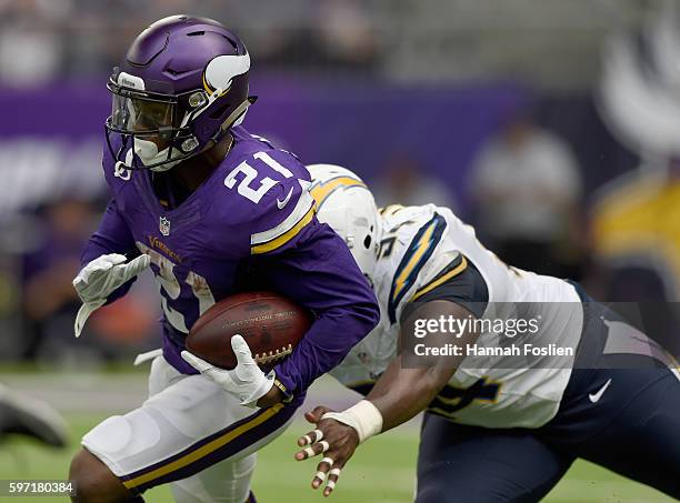 Jerick McKinnon of the Minnesota Vikings carries the ball against Corey Liuget of the San Diego Chargers during the second quarter of the game on...