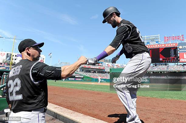 David Dahl of the Colorado Rockies celebrates with manager Walt Weiss after hitting a home run in the third inning against the Washington Nationals...