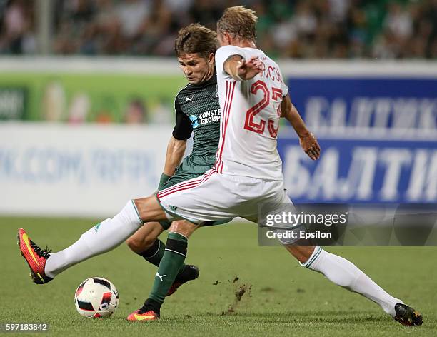 Dmitri Torbinski of FC Krasnodar is challenged by Dmitri Tarasov of FC Lokomotiv Moscow during the Russian Premier League match between FC Krasnodar...