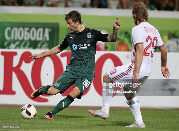 Fedor Smolov of FC Krasnodar is challenged by Vitaliy Denisov of FC Lokomotiv Moscow during the Russian Premier League match between FC Krasnodar v...