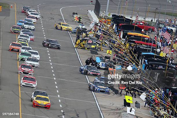 Joey Logano, driver of the Shell Pennzoil Ford, pits during the NASCAR Sprint Cup Series Pure Michigan 400 at Michigan International Speedway on...