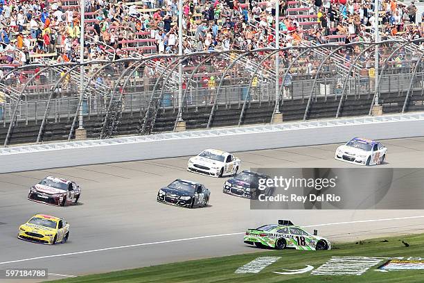 Kyle Busch, driver of the Interstate Batteries Toyota, spins during an on track incident during the NASCAR Sprint Cup Series Pure Michigan 400 at...