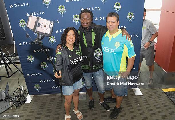 Seattle Sounders alum Steve Zakuani poses for a selfie with fans before the Delta Fabric of Sounders FC Fan Flight to Portland on August 28, 2016 in...