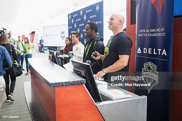 Seattle Sounders alumni Steve Zakuani and Marcus Hahnemann speak to fans in the terminal before the Delta Fabric of Sounders FC Fan Flight to...