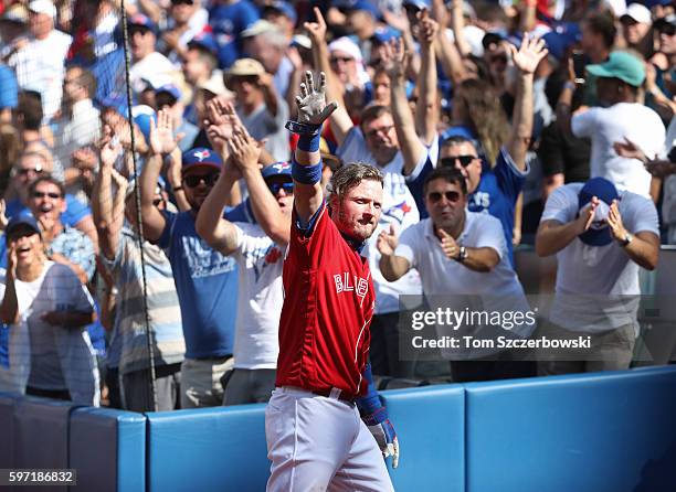 Josh Donaldson of the Toronto Blue Jays comes out of the dugout for a curtain call after hitting his home run of the game in the eighth inning during...