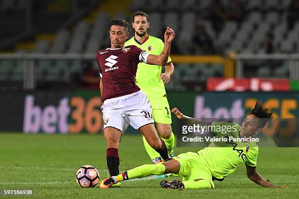 Giuseppe Vives of FC Torino is tackled Erick Pulgar of Bologna FC during the Serie A match between FC Torino and Bologna FC at Stadio Olimpico di...