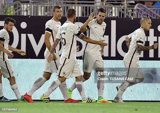 Roma's Dutch midfielder Kevin Strootman celebrates with his teammates after scoring a goal during the Serie A football match between Cagliari and...