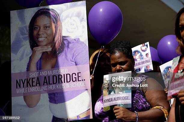 People attend a prayer vigil for Nykea Aldridge outside Willie Mae Morris Empowerment Center on August 28, 2016 in Chicago, Illinois. Nykea Aldridge,...