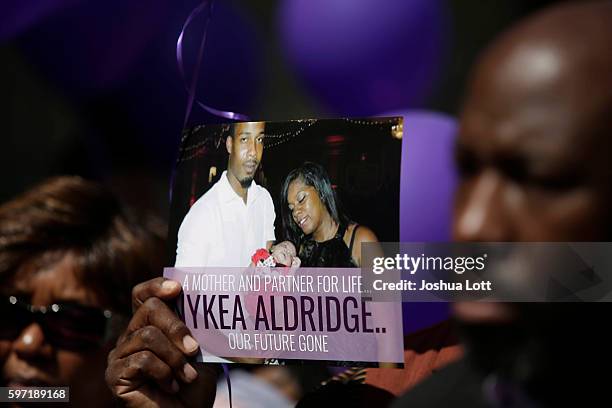 People attend a prayer vigil for Nykea Aldridge outside Willie Mae Morris Empowerment Center on August 28, 2016 in Chicago, Illinois. Nykea Aldridge,...