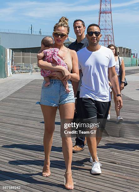 Chrissy Teigen and John Legend are seen walking to "Sports Illustrated" event at Coney Island on August 28, 2016 in New York City.