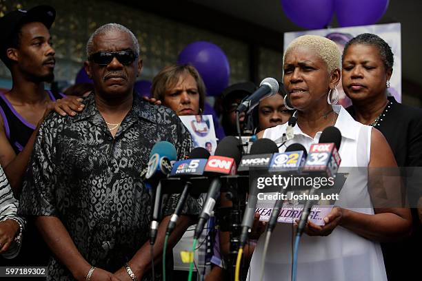 Diann Aldridge, the mother of Nykea Aldridge speaks to reporters during a prayer vigil for her daughter as her sister and Jolinda Wade, right, looks...