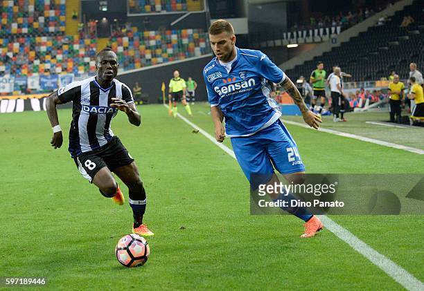 Emmanuel Agyemang Badu of Udinese Calcio competes with AUros Cosic of Empoli FC during the Serie A match between Udinese Calcio and Empoli FC at...