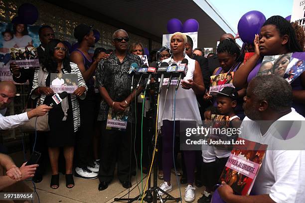 Diann Aldridge, the mother of Nykea Aldridge, center, speaks to reporters during a prayer vigil for her daughter outside Willie Mae Morris...