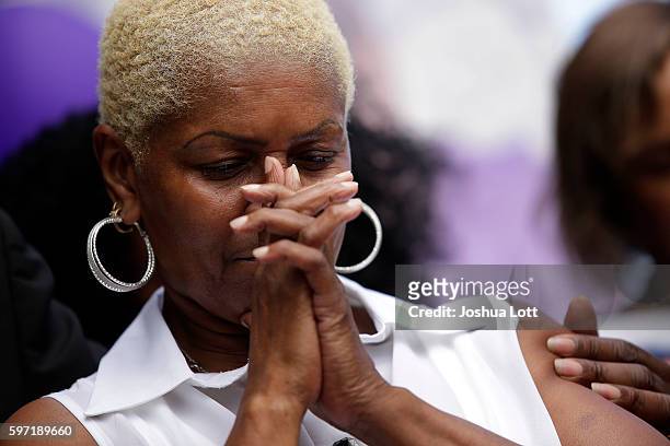 Diann Aldridge, the mother of Nykea Aldridge bows her head during a prayer vigil for her daughter outside Willie Mae Morris Empowerment Center on...