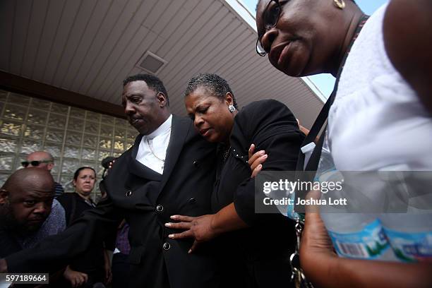 Jolinda Wade, center, the aunt of Nykea Aldridge and mother of basketball player Dwyane Wade, is lead away after being overcome by emotions during a...