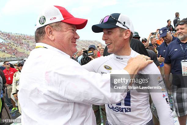 Team owner Chip Ganassi and Jamie McMurray, driver of the Cessna Chevrolet, embrace in victory lane after teammate Kyle Larson, driver of the Target...