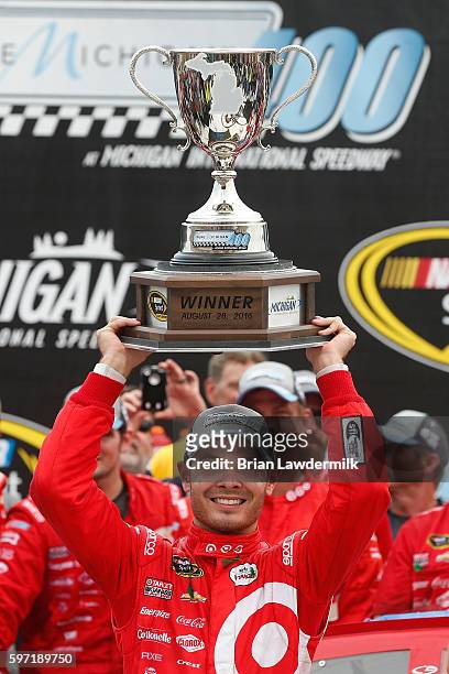 Kyle Larson, driver of the Target Chevrolet, celebrates in victory lane after winning the NASCAR Sprint Cup Series Pure Michigan 400 at Michigan...
