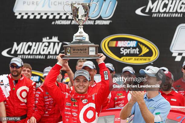 Kyle Larson, driver of the Target Chevrolet, celebrates in victory lane after winning the NASCAR Sprint Cup Series Pure Michigan 400 at Michigan...