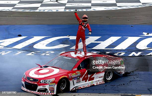 Kyle Larson, driver of the Target Chevrolet, celebrates after winning the NASCAR Sprint Cup Series Pure Michigan 400 at Michigan International...