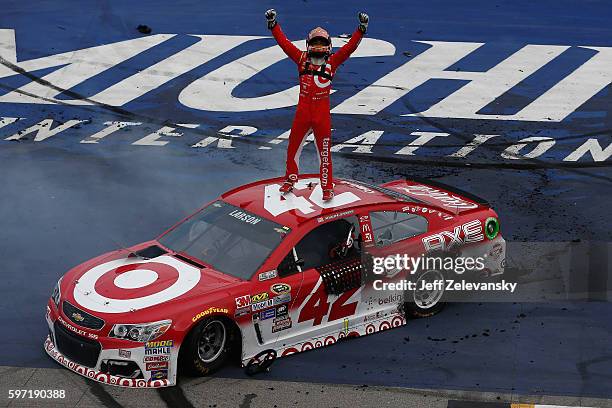 Kyle Larson, driver of the Target Chevrolet, celebrates after winning the NASCAR Sprint Cup Series Pure Michigan 400 at Michigan International...