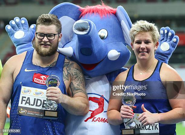 Poland's Olympic champion Anita Wlodarczyk pose with Pael Fajdek after breaking her own world record in the Women's Hammer Throw during the athletics...