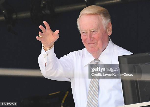 Los Angeles Dodgers broadcaster Vin Scully acknowledges the umpired crew before the start of the game against the Chicago Cubs at Dodger Stadium on...