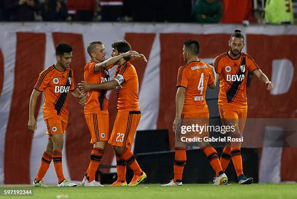 Andres D'Alessandro of River Plate celebrates with teammates after scoring the third goal of his team during a match between River Plate and Banfield...