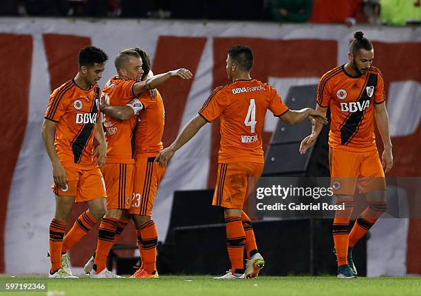 Andres D'Alessandro of River Plate celebrates with teammates after scoring the third goal of his team during a match between River Plate and Banfield...