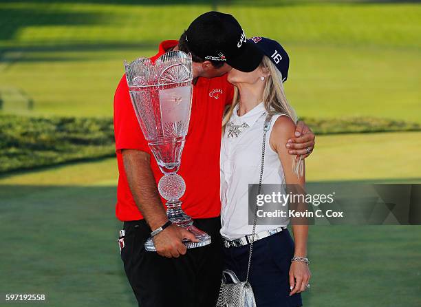 Patrick Reed poses with his wife Justine and the trophy after winning The Barclays in the PGA Tour FedExCup Play-Offs on the Black Course at Bethpage...