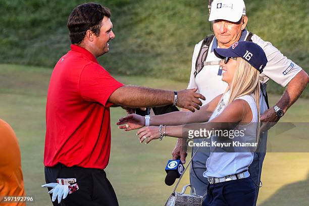 Patrick Reed hugs his wife Justine Reed following his one stroke victory on the 18th hole green during the final round of The Barclays at Bethpage...