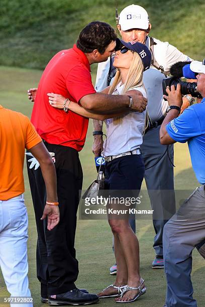 Patrick Reed kisses his wife Justine Reed following his one stroke victory on the 18th hole green during the final round of The Barclays at Bethpage...