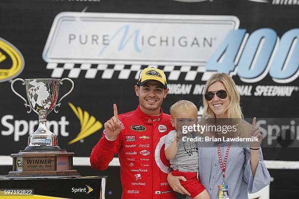 Kyle Larson, driver of the Target Chevrolet, girlfriend Katelyn Sweet and son Owen Larson celebrate in Victory Lane after winning the NASCAR Sprint...