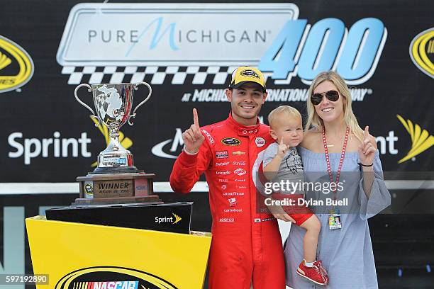 Kyle Larson, driver of the Target Chevrolet, girlfriend Katelyn Sweet and son Owen Larson celebrate in Victory Lane after winning the NASCAR Sprint...