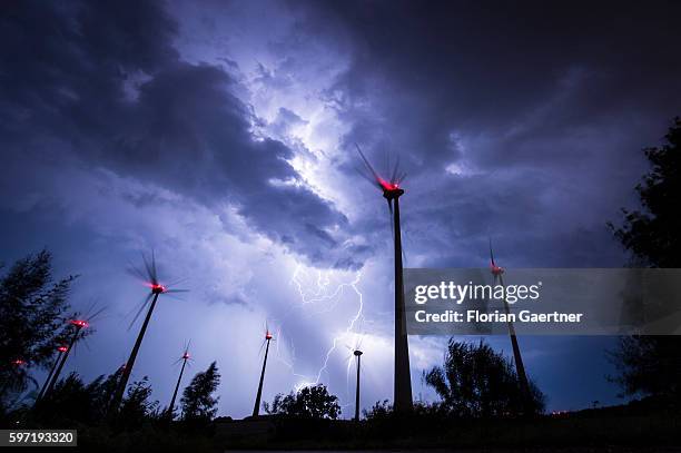 Lightning strikes behind wind turbines during a thunderstorm near the border between Germany and Poland on August 28, 2016 in Goerlitz, Germany....