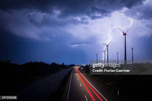 Lightning strikes behind wind turbines during a thunderstorm near the border between Germany and Poland on August 28, 2016 in Goerlitz, Germany....