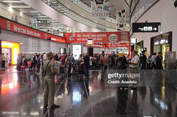 Passengers wait at the Vienna International Airport in Schwechat, Vienna, Austria on August 28, 2016 due to a technical fault in airport that causes...