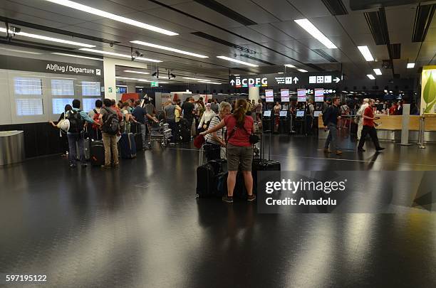 Passengers wait at the Vienna International Airport in Schwechat, Vienna, Austria on August 28, 2016 due to a technical fault in airport that causes...