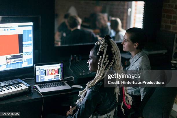 female sound engineers watching a band playing - sound recording equipment stock-fotos und bilder