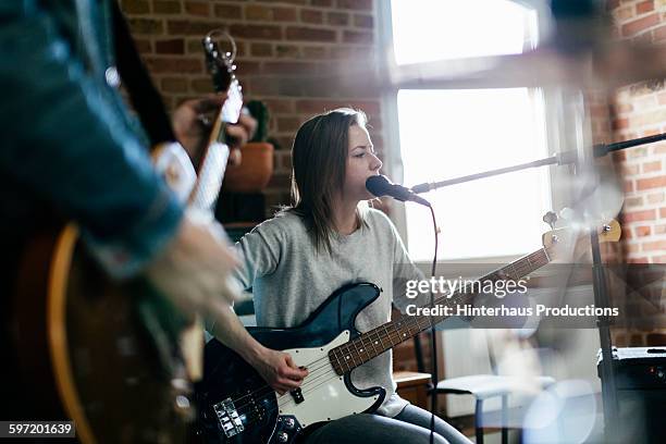 singer playing guitar and performing a song - color day productions stockfoto's en -beelden