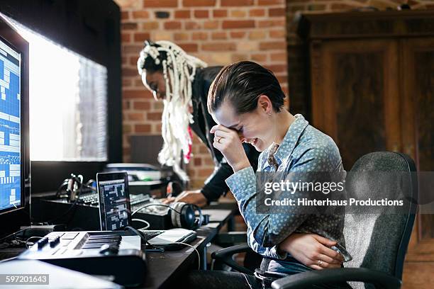 sound engineer laughing in record studio - sound producer stock pictures, royalty-free photos & images