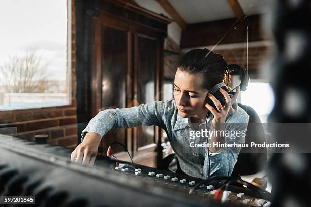 female sound engineer in a recording studio - musik stock-fotos und bilder